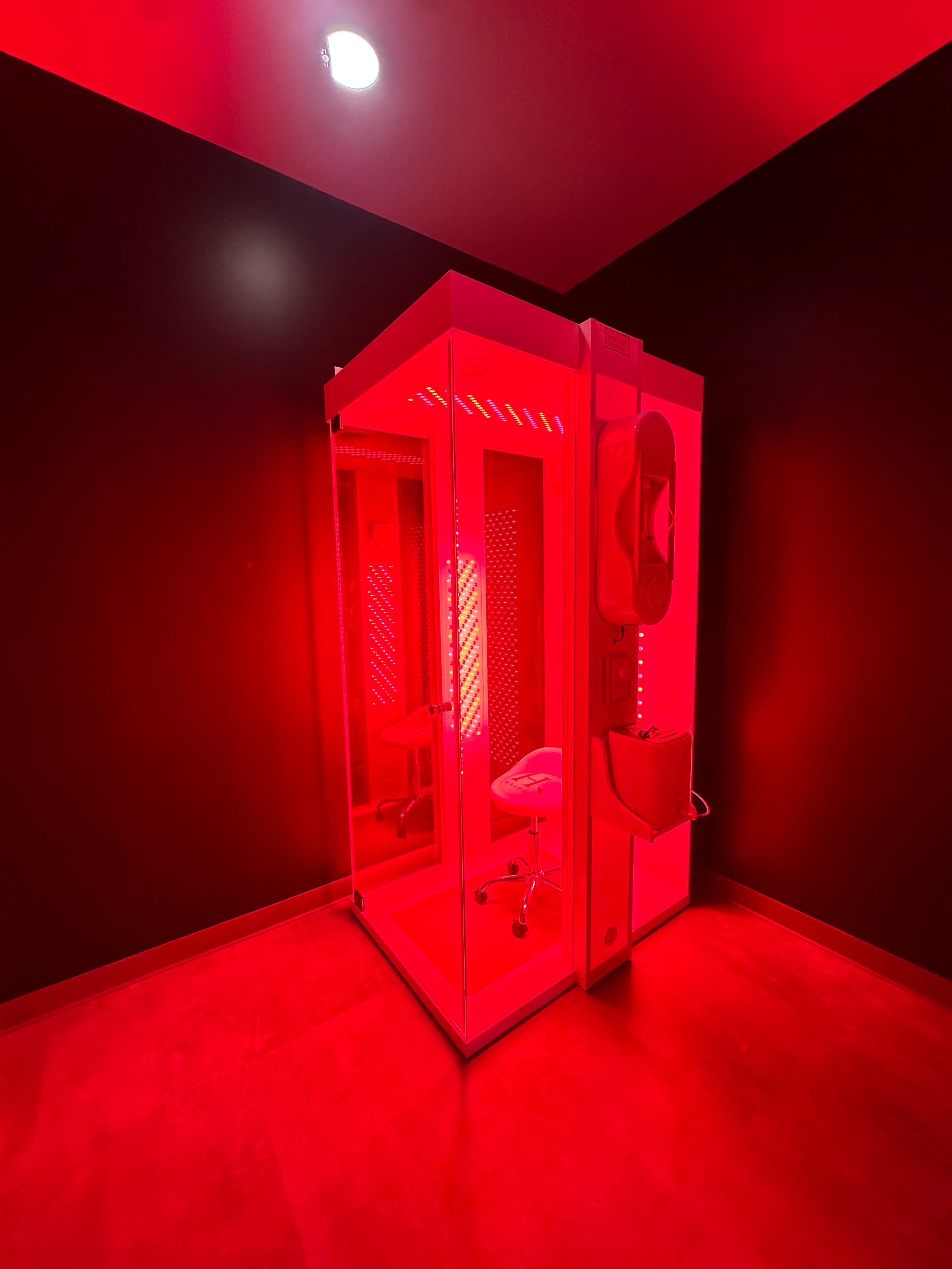 The HaloRed O₂ recovery booth at TNU Fitness with its red light therapy panels lit